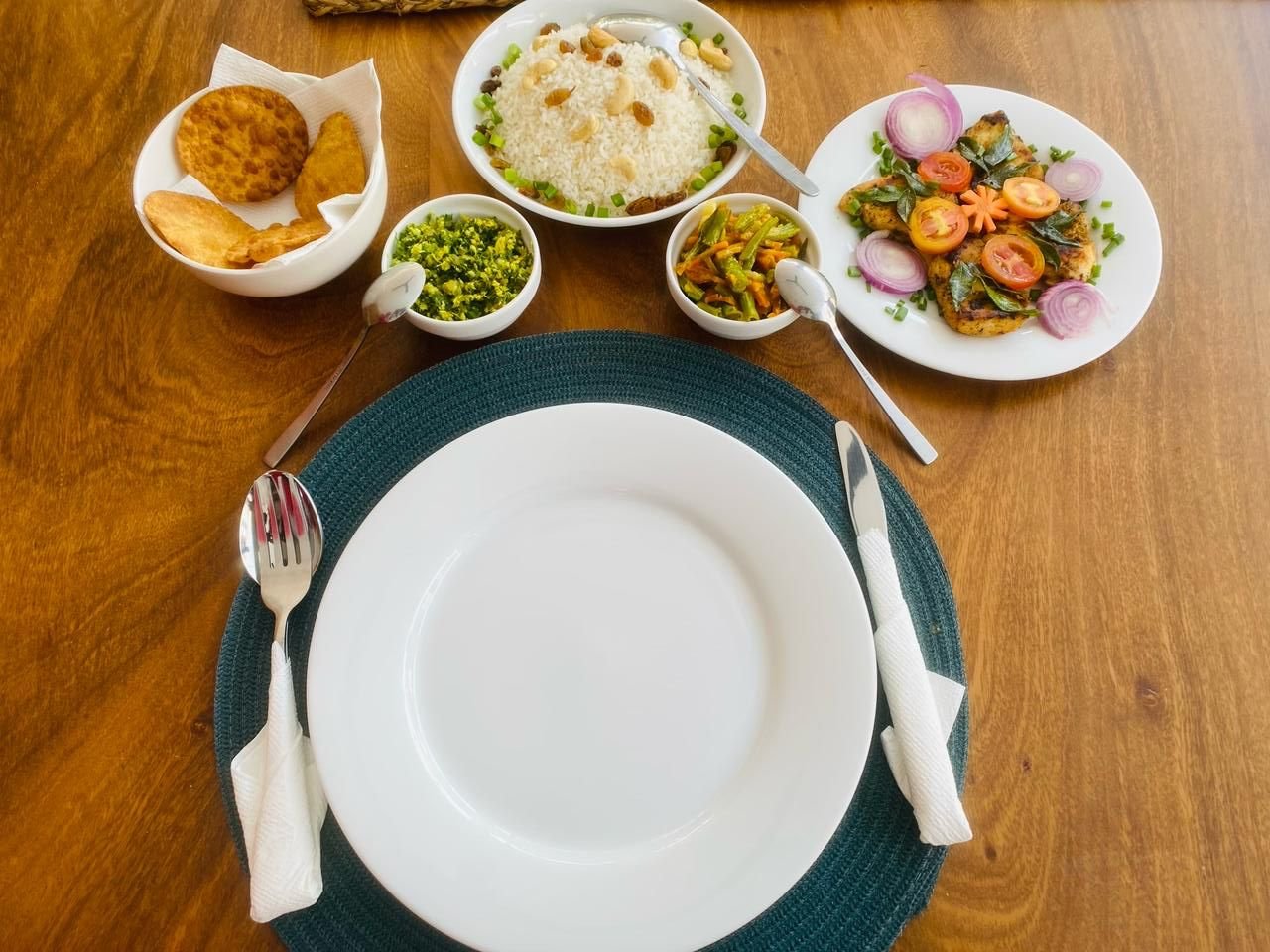 Ko Lake chef prepared: Flavorful Sri Lankan Dinner Spread - Ko Lake Villa boutique lakefront accommodation on Koggala Lake Sri Lanka: Delicious Sri Lankan dinner featuring rice with cashews, spicy stir-fried vegetables, flavorful fish, and crispy fritters. A complete meal.