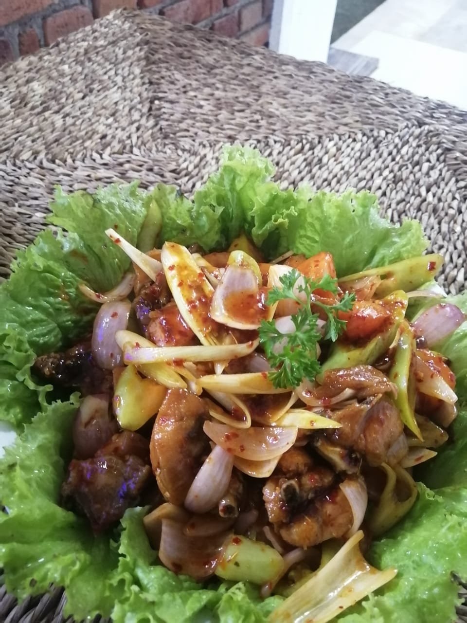 Spicy Asian Chicken & Veggie Stir Fry on Lettuce - Ko Lake Villa boutique lakefront accommodation on Koggala Lake Sri Lanka: Delicious spicy Asian chicken stir-fry with onions, peppers, and unknown vegetables, served on fresh lettuce. Perfect for a savory meal.