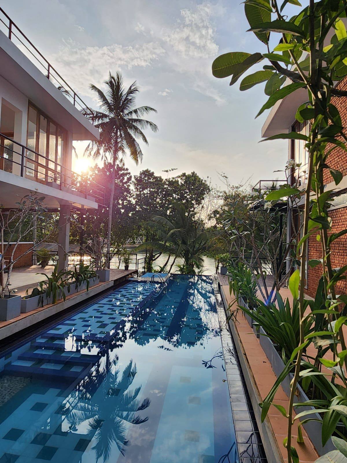 Ko Lakside Pool Villa Sunset - Tropical Escape - Ko Lake Villa boutique lakefront accommodation on Koggala Lake Sri Lanka: Experience serene sunsets at this luxurious riverside pool villa. Palm trees, sparkling water, and tropical vibes create the perfect getaway.