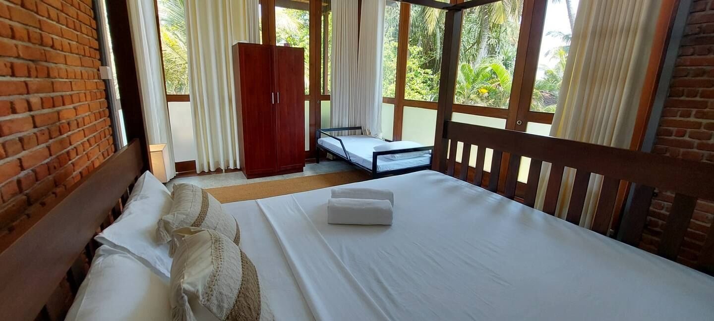 HighLake Bedroom r6 - Ko Lake Villa boutique lakefront accommodation on Koggala Lake Sri Lanka: Double room configured with 3 daybed sleeps three / Tripple