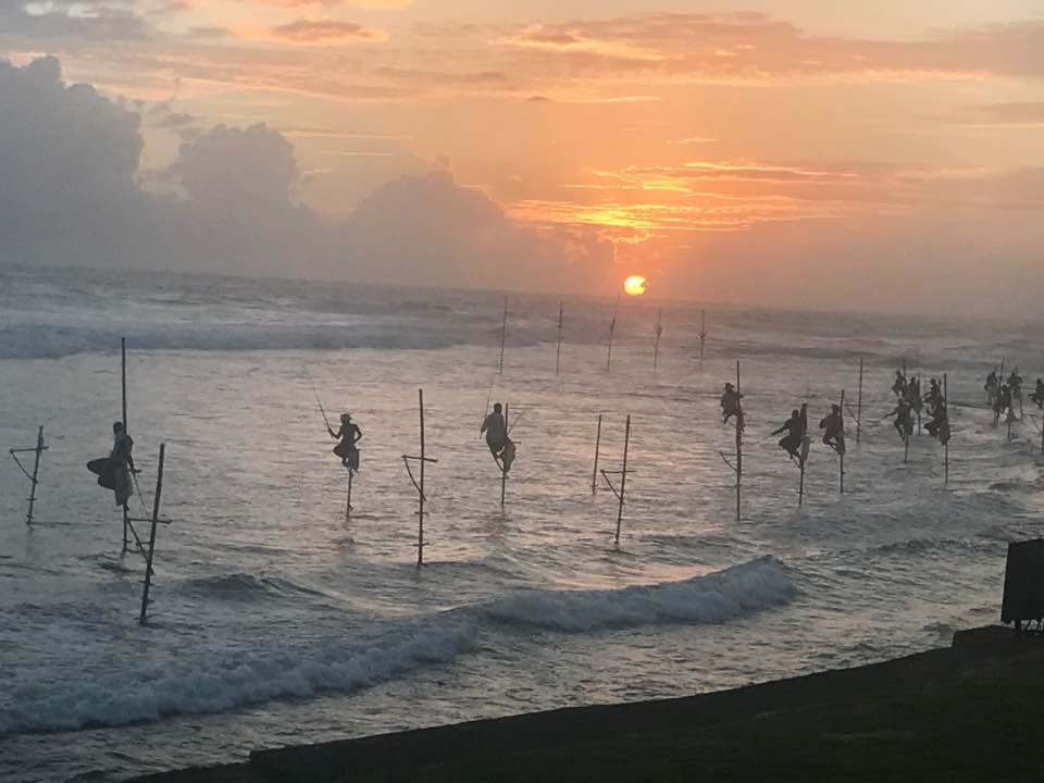 Stilt Fishermen at Sunset, 600 yards away - Ko Lake Villa boutique lakefront accommodation on Koggala Lake Sri Lanka: Witness the iconic stilt fishermen against a breathtaking sunset near Ko Lake Villa. Experience unique Sri Lankan culture and stunning views.