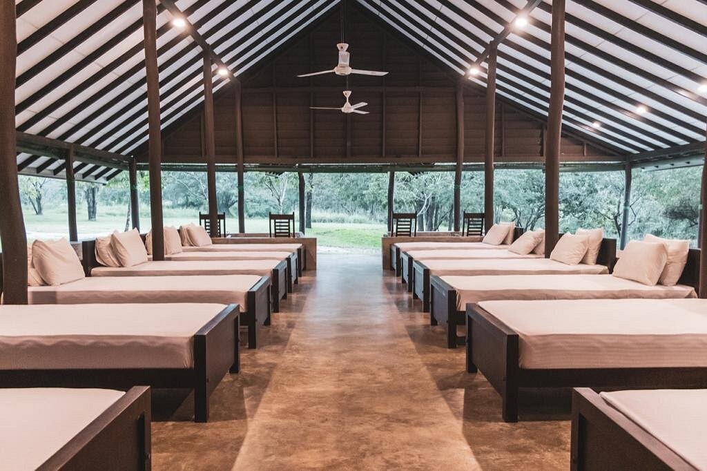 Rustic Safari Lodge Dormitory at Governers Camo with Nature Views - Ko Lake Villa boutique lakefront accommodation on Koggala Lake Sri Lanka: Experience communal comfort in this safari lodge dormitory. Features multiple beds, open-air design, and direct views of lush greenery.