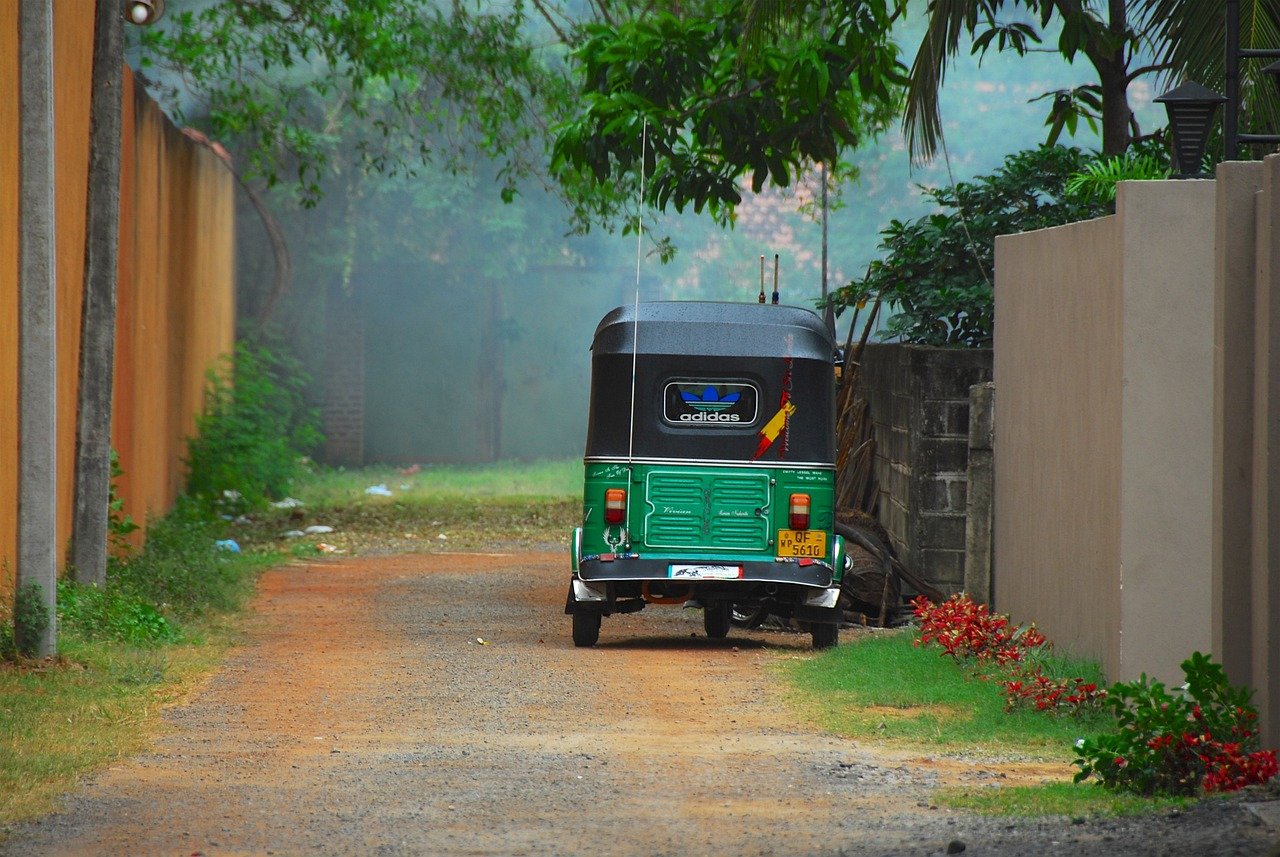 Green Rickshaw on back Road in Sri Lanka - Ko Lake Villa boutique lakefront accommodation on Koggala Lake Sri Lanka: The most popular and valuable transport.
Sri Lanka, rural areas have poor, unpaved roads, lush tropical foliage, for which the Tuk is well-suited