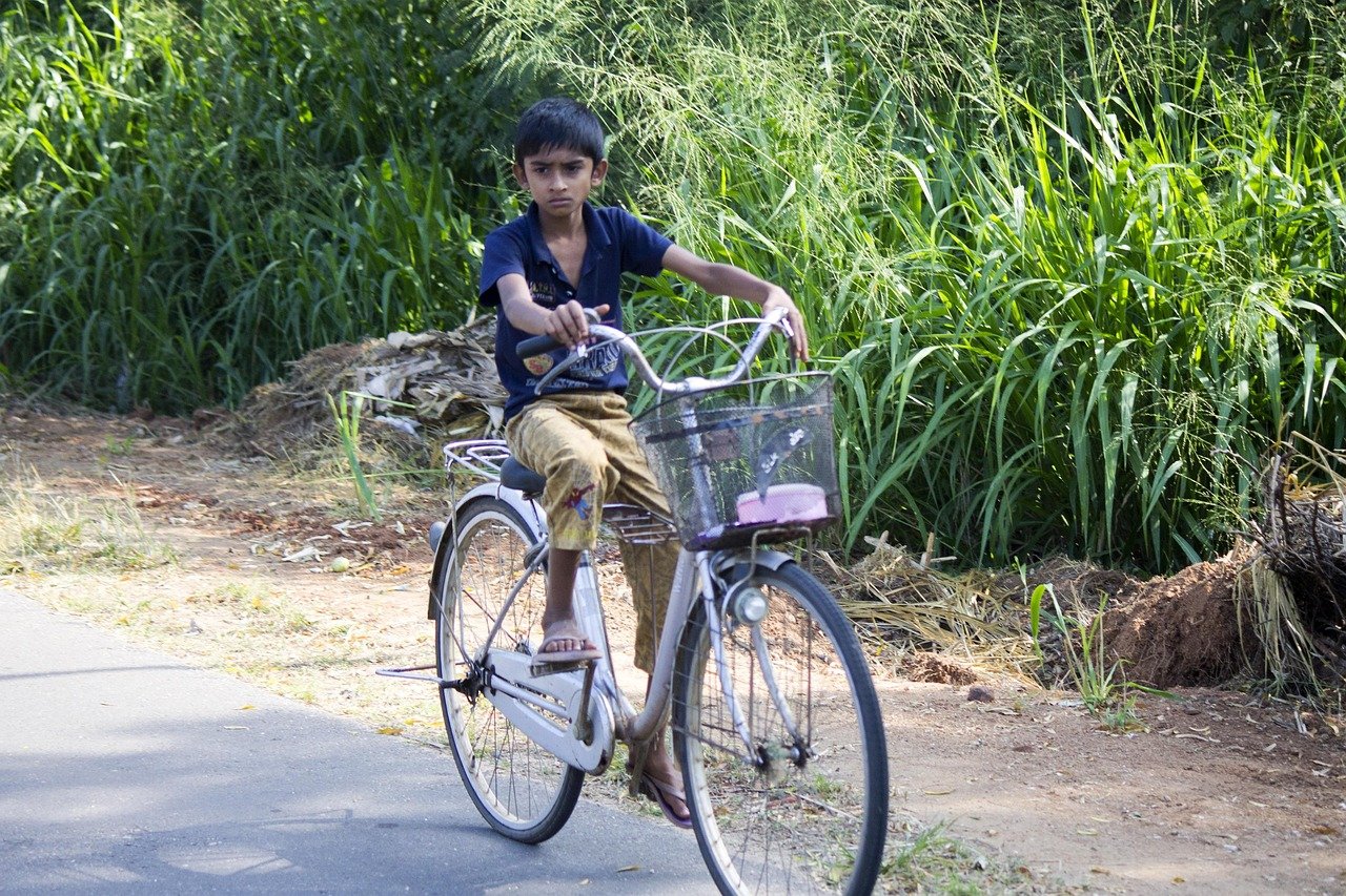 Koggala road Bicycle is still part of rural life - Ko Lake Villa boutique lakefront accommodation on Koggala Lake Sri Lanka: A captivating young boy riding an old bicycle on a rural road near Koggala, surrounded by lush green foliage.
Perfect for relaxing hikes or strolls.
