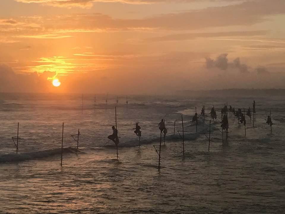 Sri Lanka Stilt Fishing Sunset - Traditional Fishermen a few hundrreed yards - Ko Lake Villa boutique lakefront accommodation on Koggala Lake Sri Lanka: Stroll ma few yards and Witness the iconic stilt fishermen of Sri Lanka at sunset. A mesmerizing glimpse into traditional fishing culture and a beautiful orange sky.